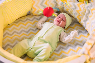 cute newborn baby crying in the crib