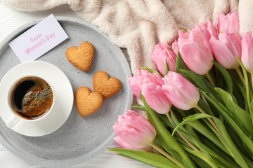 Composition with pink tulips on white wooden background, top view