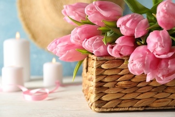 Composition with tulips in wicker basket, close up