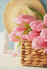 Composition with tulips in wicker basket, close up