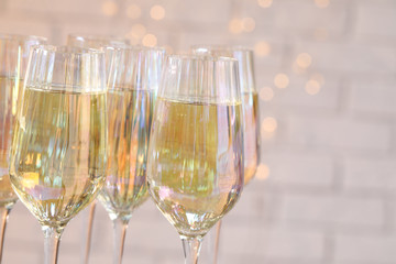 Glasses of champagne against blurred lights, closeup