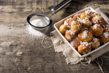Carnival fritters or buñuelos de viento for holy week on wooden table copy space