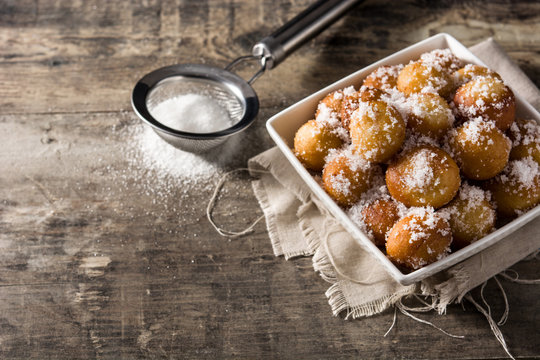 Carnival fritters or bu&ntilde;uelos de viento for holy week on wooden table copy space