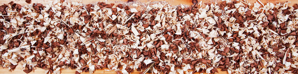 Long panorama of wood chip shavings for themes and concepts of DIY, natural designs, wood work, home improvment, building and making stuff - creative & inspirational background texture.