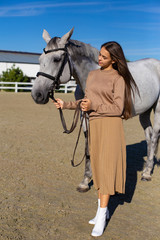 vertical photo of a young girl with a beautiful horse