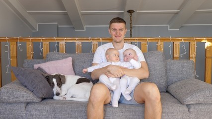 Happy Father With His Baby Twins.