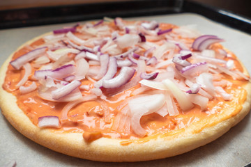 Pizza making process	Pizza dough with raw ingredients