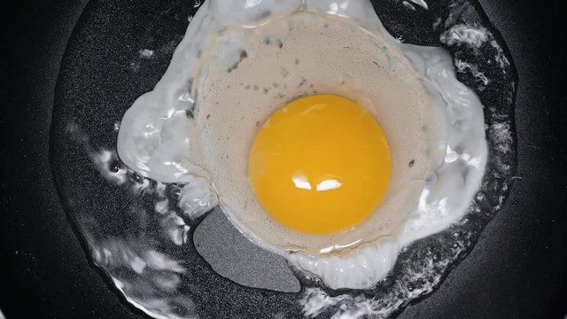 cropped view of man frying egg