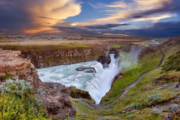 Panoramic view on Gullfoss waterfall on the Hvíta river, a popular tourist attraction and part of the Golden Circle Tourist Route in Southwest Iceland. Golden Waterfall. Travelling concept background.