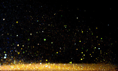 glitter vintage lights background. gold and black. de focused