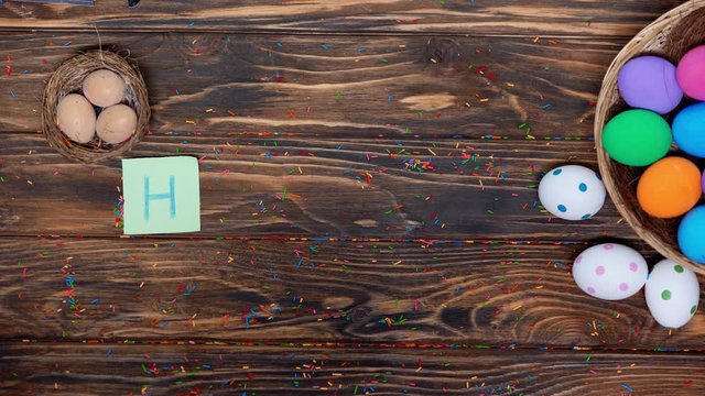 top view of man putting papers with happy easter lettering near painted eggs
