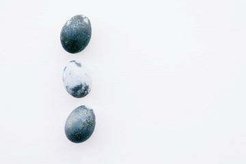Natural dyed blue colored eggs on white background.