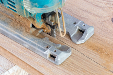 Close-up of a cut floor panel using a jigsaw.