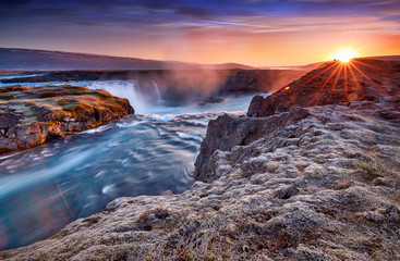 Incredible frosty morning and sunrise at the most famous place of Golden Ring Of Iceland. Godafoss waterfall near Akureyri in the Icelandic highlands, Europe. Popular tourist attraction. Postcard.