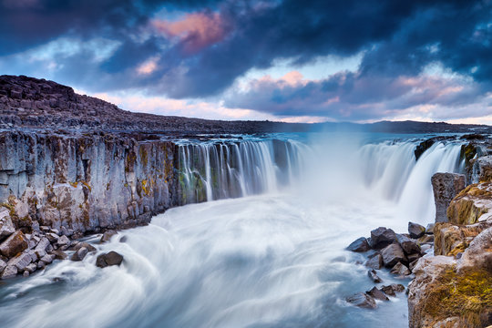 Colorful clouds over Selfoss waterfall. Iceland, Jokulsa National Park, Fjollum river, Europe. . Popular tourist attraction. Travelling concept background. Golden Ring Of Iceland. Beautiful Postcard. © zicksvift