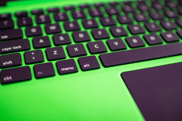 black keyboard on a green laptop. keys with letters and numbers. Detail of a laptop computer. Image...