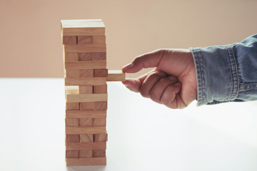 close up of hand businessman playing block wood