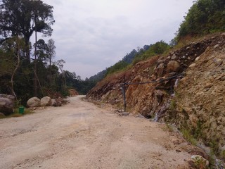 waterfall near the road with cables