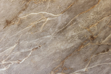 Brown-white marbled pattern with gold streaks. Abstract texture and background.