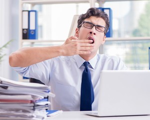 Tired exhausted businessman sitting in the office