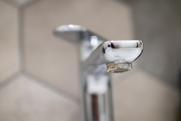 Calcium deposit problem on tap to be repaired by plumber. Limestone-encrusted problem with water...