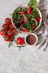 Fresh green mixed salad with cherry tomatoes in a wooden bowl