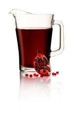 Pomegranete juice in jug on white cutout background with reflection.