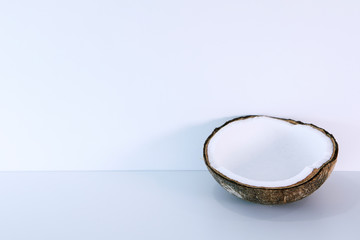 Half of fresh coconut on white background with copy space.