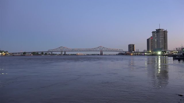 Mississippi river with the Crescent City Connection bridge by evening. New Orleans, Louisiana, USA