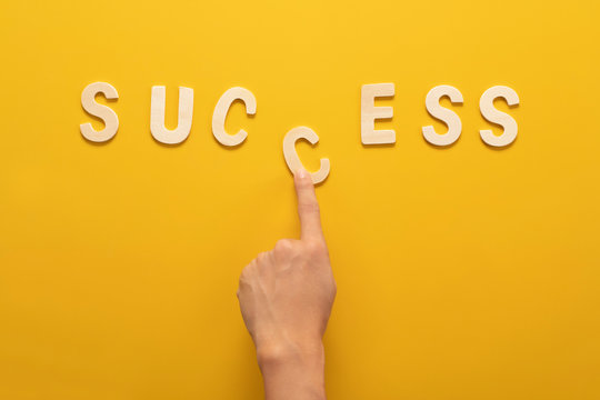 success wooden wording over yellow background in vision and idea conceptual image