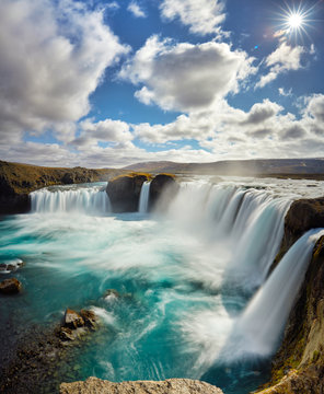 Panorama of most famous place of Golden Ring Of Iceland. Godafoss waterfall near Akureyri in the Icelandic highlands, Europe. Popular tourist attraction. Travelling concept background. Postcard.