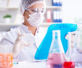 Female scientist researcher conducting an experiment in a labora