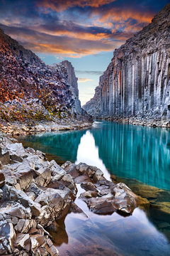 Studlagil basalt canyon, Jokulsa a Dal River. Iceland, Europe.  One of the most wonderfull hidden place and nature sightseeing. Famous tourist landscape with basalt rock formations. Travel postcard.