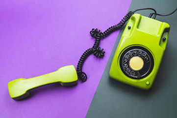 Classic phone with handset. vintage green telephone with phone receiver isolated on color background. old communication technology