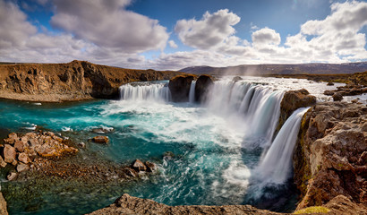 Panorama of most famous place of Golden Ring Of Iceland. Godafoss waterfall near Akureyri in the Icelandic highlands, Europe. Popular tourist attraction. Travelling concept background. Postcard. - obrazy, fototapety, plakaty