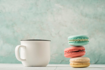pile of macaroons and a cup of coffee on table