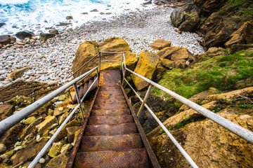 Fototapeta na wymiar Stairway access Playa de Piedras, La Tablia, Spain