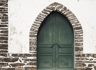 Religious Monument with a closed green door, located in Mondim de Basto, Portugal.