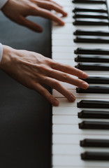Hands of musician. Pianist playing on a midi keyboard indoor