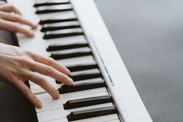 Hands of musician. Pianist playing on a midi keyboard indoor