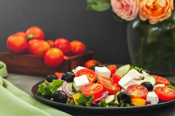 Greek salad of fresh cucumber, tomato, sweet pepper, lettuce, feta cheese and olives with olive oil. Healthy food