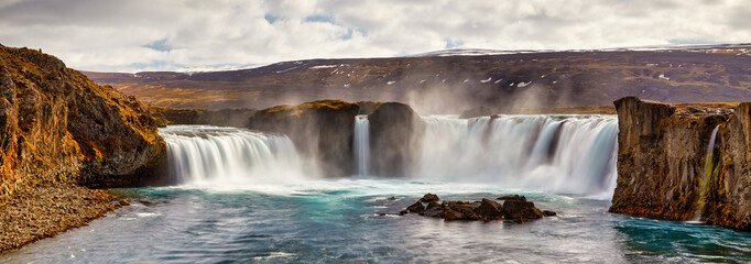 Panorama of most famous place of Golden Ring Of Iceland. Godafoss waterfall near Akureyri in the Icelandic highlands, Europe. Popular tourist attraction. Travelling concept background. Postcard.