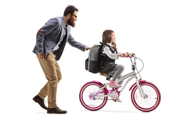 Fototapeta na wymiar Father teaching a girl to ride a bicycle