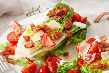 romaine lettuce topped with bacon tomato parmesan, sauce. healthy keto paleo diet lunch