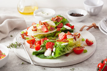 romaine lettuce topped with bacon tomato parmesan, sauce. healthy keto paleo diet lunch
