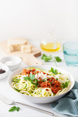 keto paleo zoodles bolognese: zucchini noodles with meat sauce and parmesan