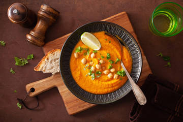 creamy carrot chickpea soup on dark rustic background