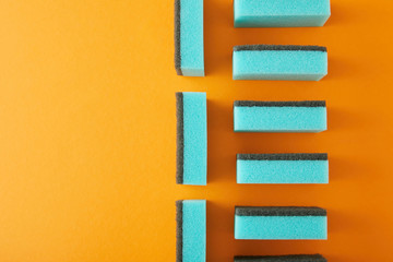 top view of blue sponges for dish washing on orange