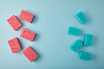 top view of blue and pink sponges for house cleaning on blue