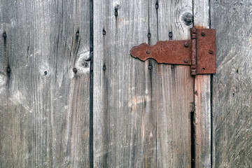 Old wooden not painted background, with rusty metal hinge